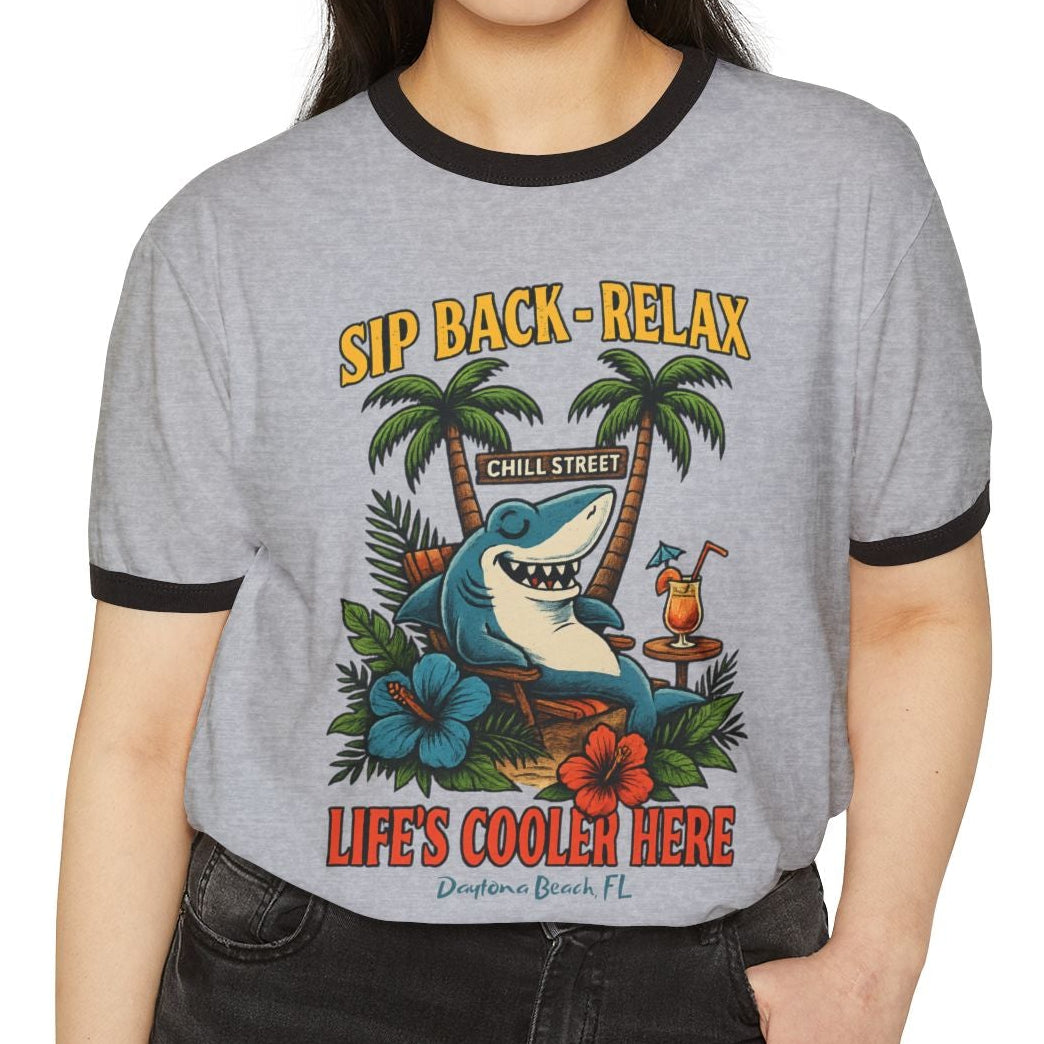 Woman wearing a gray t-shirt with a shark graphic and text on a white background