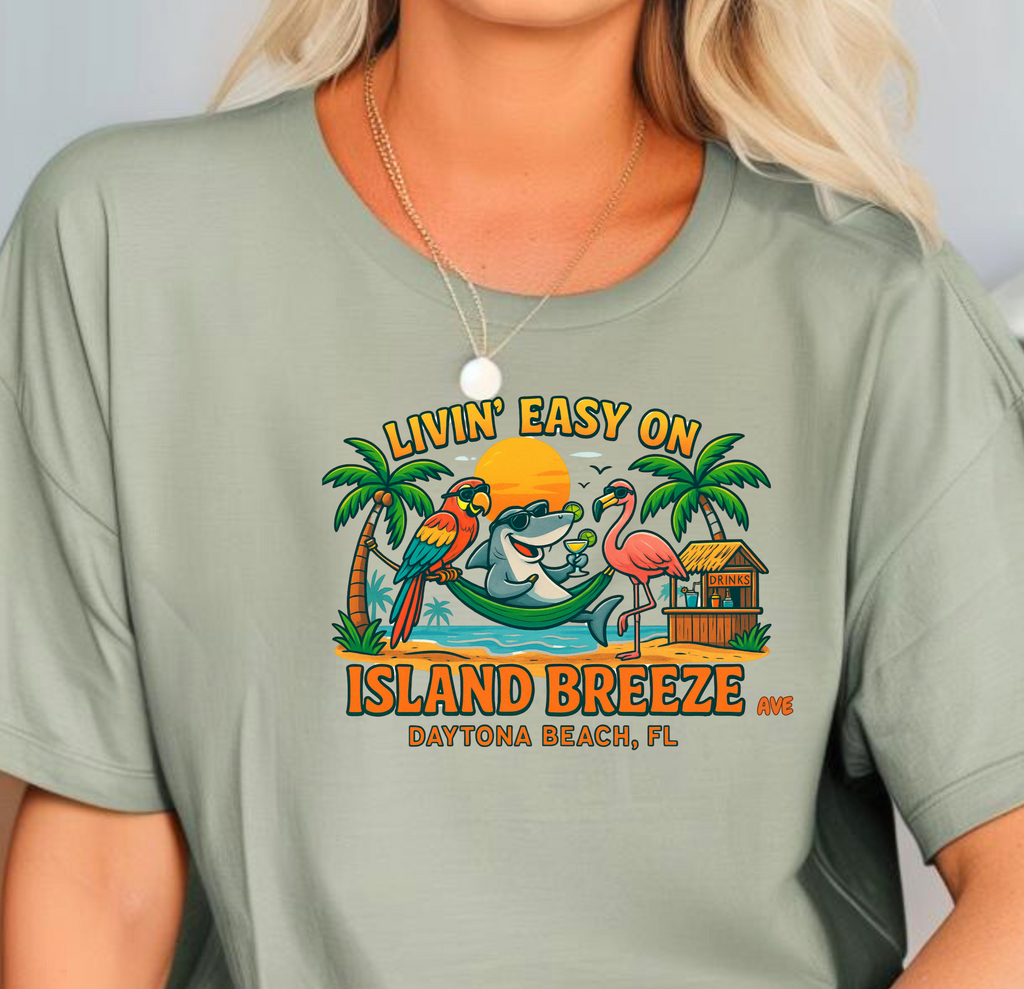 Woman wearing a green t-shirt with 'Living Easy on Island Breeze' design.