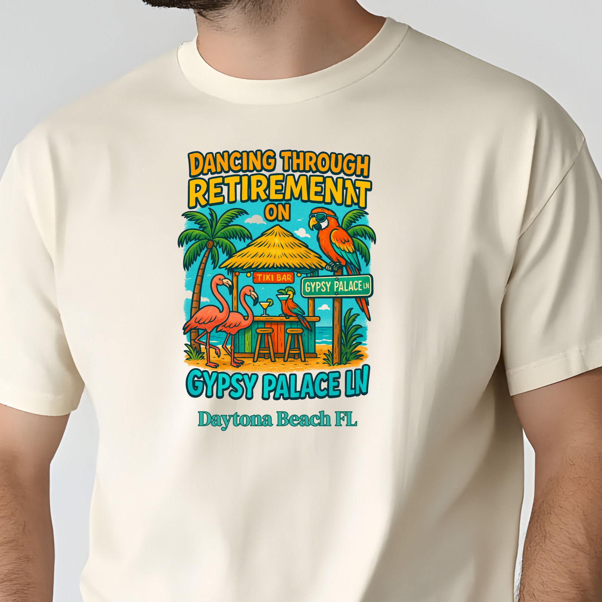 Man wearing a cream t-shirt with a colorful graphic design on a plain background