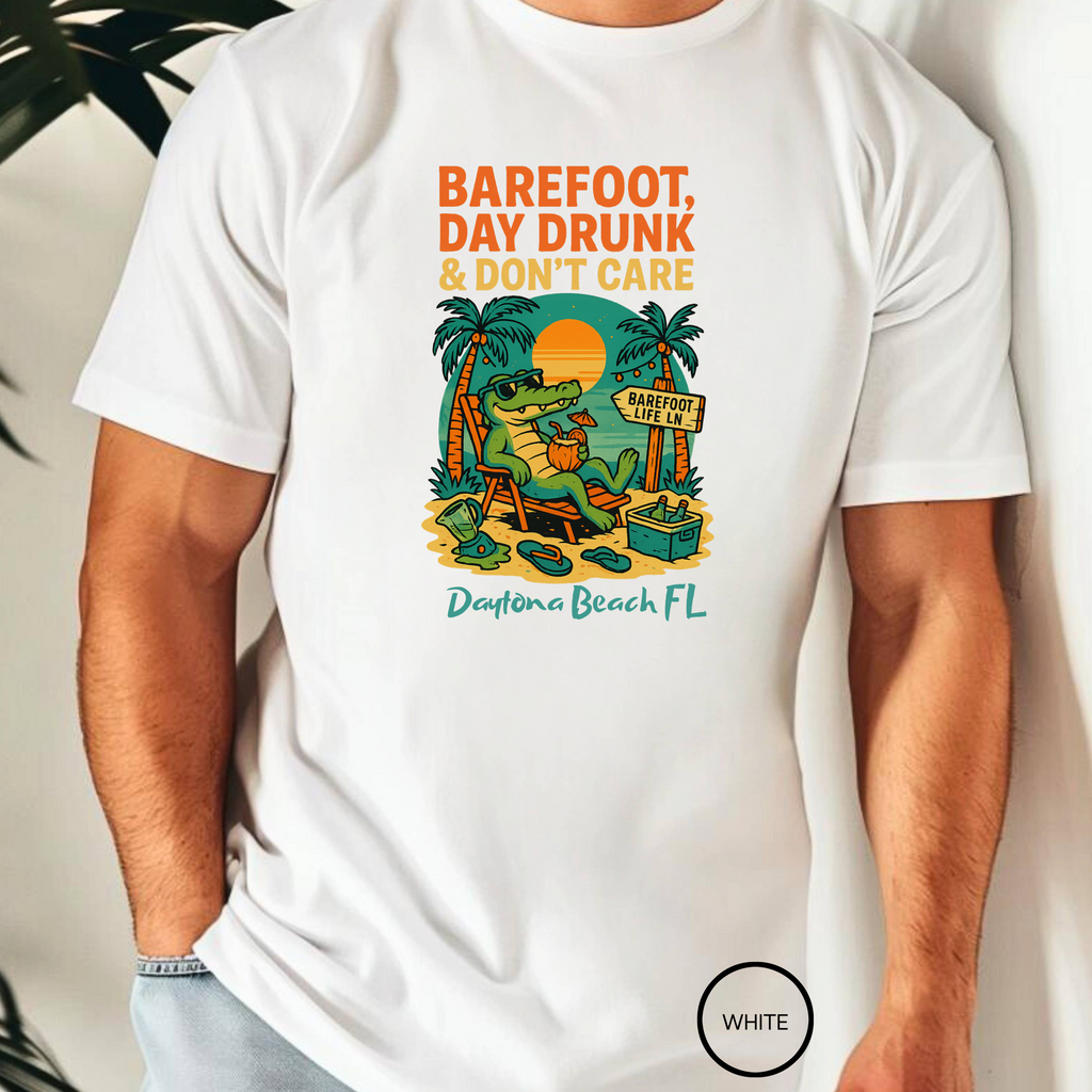 White t-shirt with a graphic design featuring an alligator, palm trees, and text on a white background.