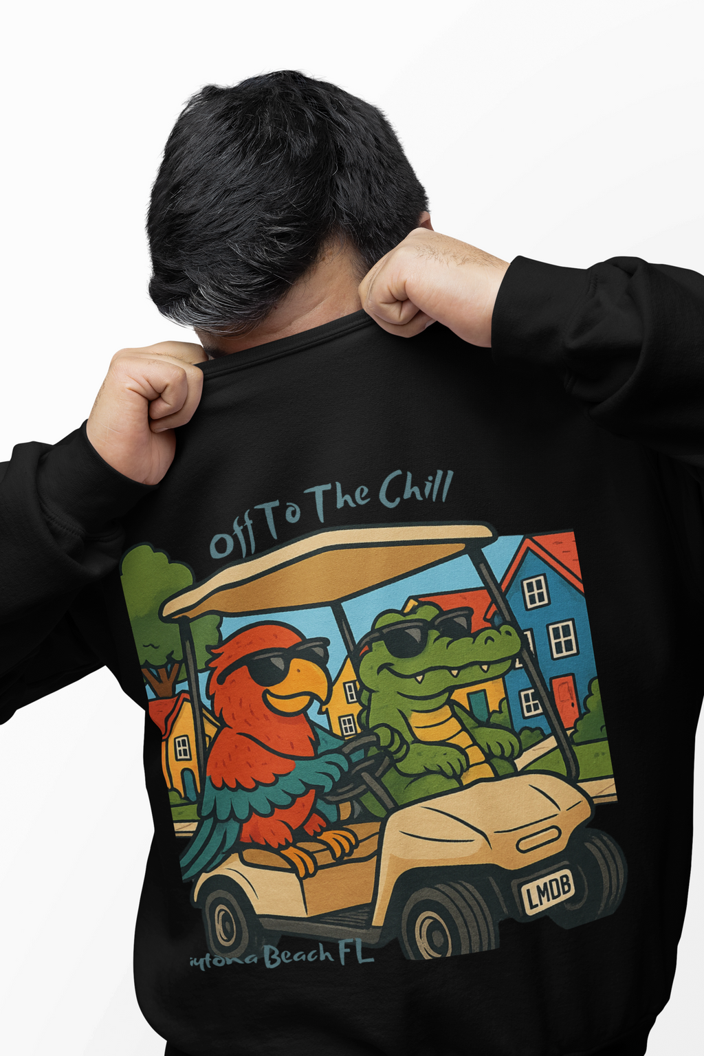 Person wearing a black sweatshirt with a colorful graphic of a parrot and frog in a golf cart, text 'Off To The Chill' and 'Mylor Beach FL'.