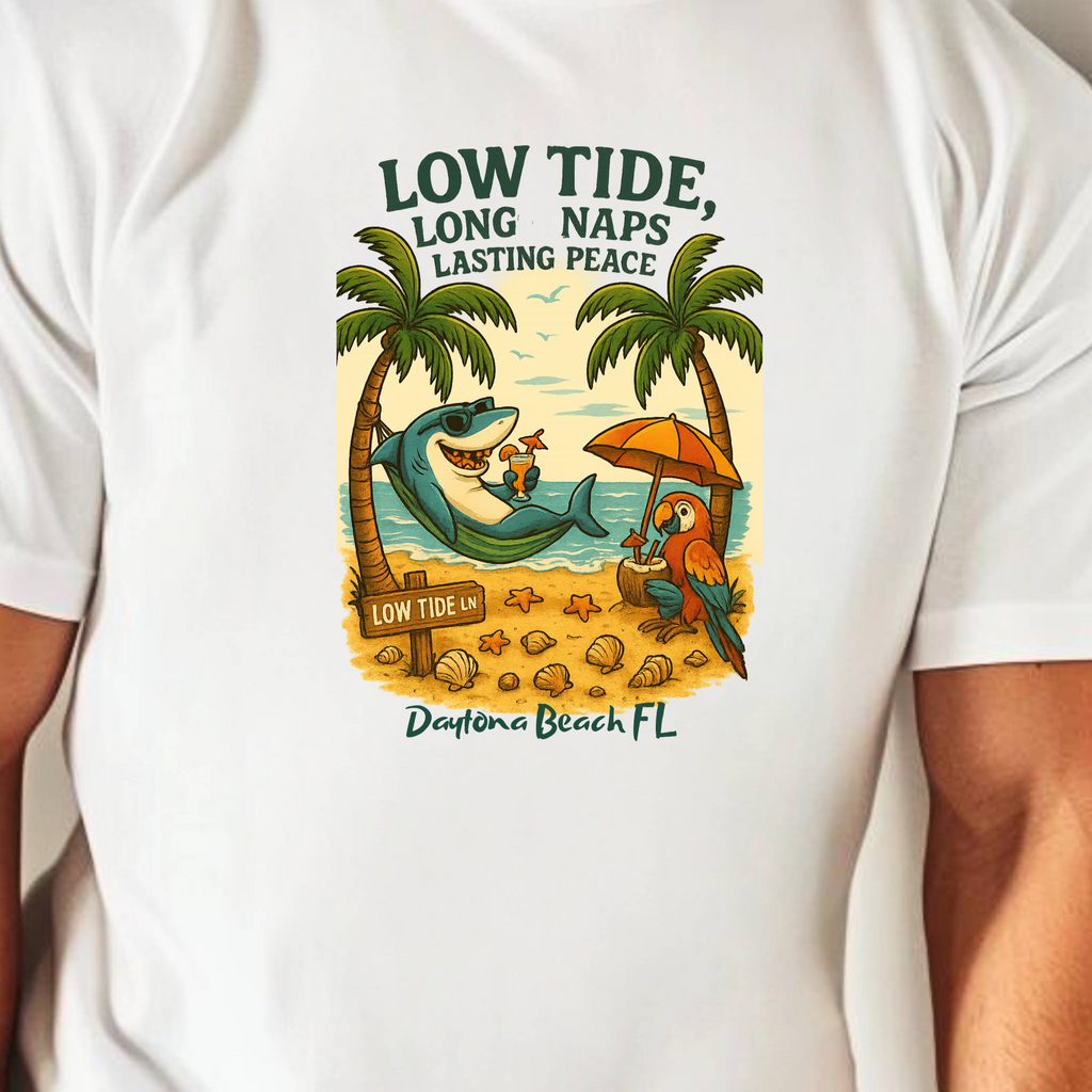 White t-shirt with a beach-themed graphic and text, worn by a person.