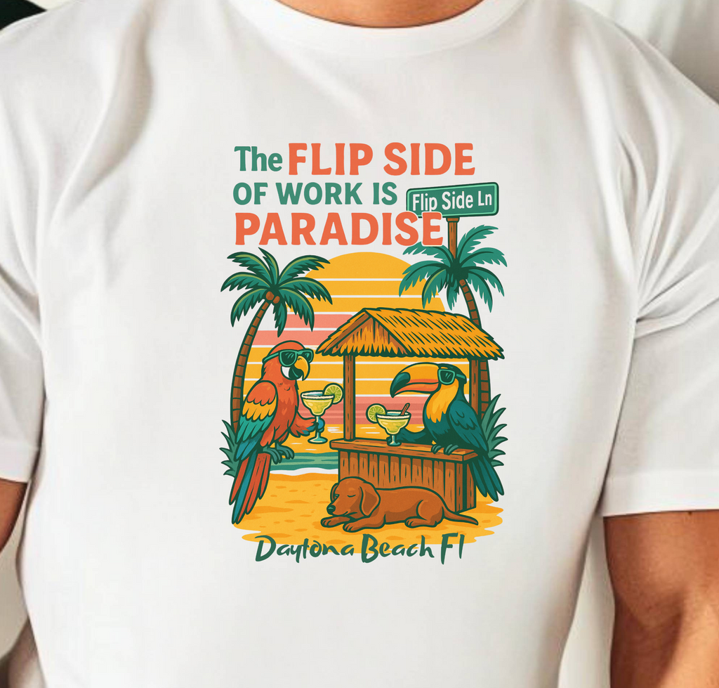 White t-shirt with a tropical design and text, worn by a person.