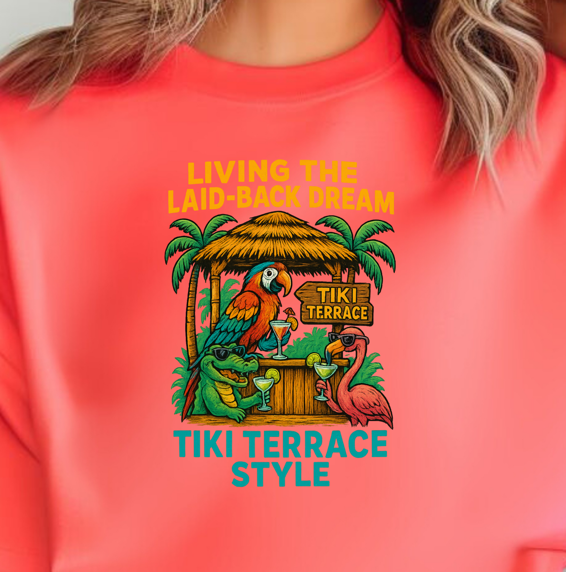 Person wearing a coral t-shirt with a tropical design and text.