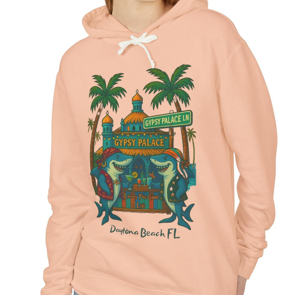 Person wearing a peach hoodie with a graphic design on a white background